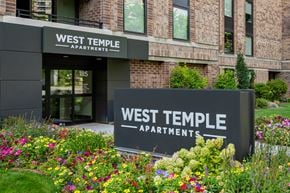 Salt Lake City apartment for rent - The West Temple Apartments building is surrounded by a colorful flower garden.