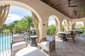 Poolside lounge with a bar, fireplace, barbecue grills, and billiards