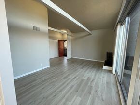 Lafayette apartment for rent - living room with wood-look flooring and a large window at 3543 Brook Street in Lafayette 94549