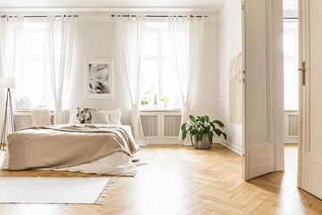 San Jose apartment for rent - a bedroom with white curtains and a bed and a wood floor