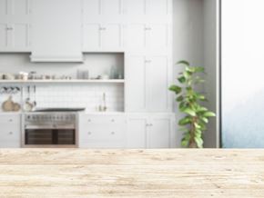 San Jose apartment for rent - a kitchen with white cabinets and a wooden table