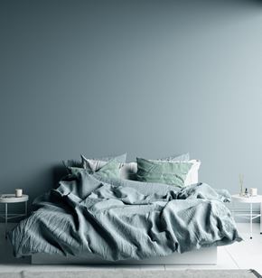 San Jose apartment for rent - a bedroom with a blue wall and a bed with a blanket on it