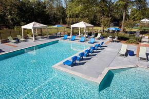 Birmingham apartment for rent - a swimming pool with blue lounge chairs and umbrellas at Inverness Cliffs, Birmingham
