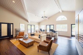 A living room with a couch and chairs and a table