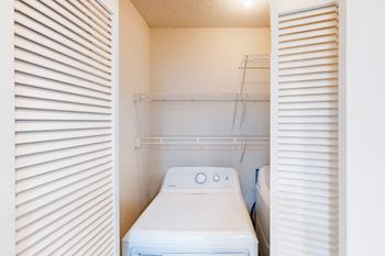 The laundry room is equipped with a washer and dryer