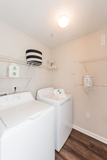 A white washing machine and dryer in a small laundry room.