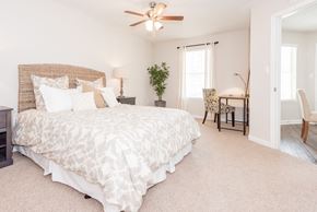 Birmingham apartment for rent - A bedroom with a large bed and a ceiling fan. at WildForest Apartments, Alabama