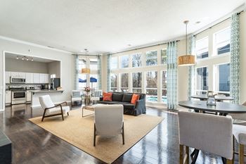 A living room with a couch and chairs and a table
