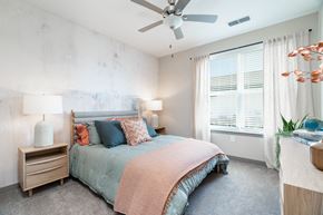Alcoa apartment for rent - A bedroom with a bed, nightstands, and a ceiling fan.