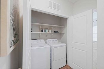 A small laundry room with a washer and dryer