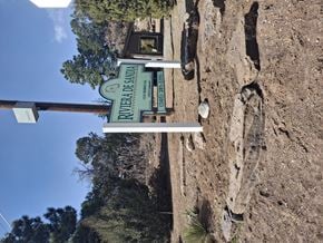 Cedar Crest apartment for rent - A sign for the Rivera de Arriba is mounted on a rocky wall.