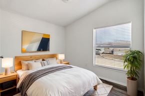 Longmont apartment for rent - A bedroom with a large bed and a painting on the wall.