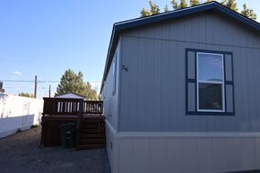 Rock Springs apartment for rent - the exterior of a tiny house with a deck and a window at Horizon MHC, Rock Springs, Wyoming