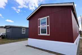 Leadville apartment for rent - the side of a red building with a window and a sidewalk