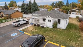 Cheyenne apartment for rent - a white house with a car parked in a parking lot at Country Lane, Wyoming, 82007