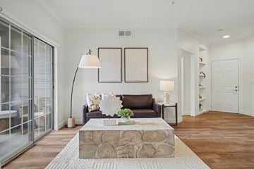 Littleton apartment for rent - A living room with a brown couch and a wooden coffee table.