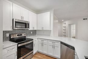 Littleton apartment for rent - A kitchen with white cabinets and appliances.
