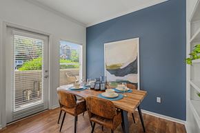 Littleton apartment for rent - A dining room with a wooden table set for two.