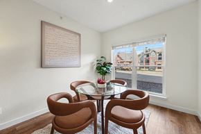 Littleton apartment for rent - A dining room with a table and chairs and a view of the street outside.