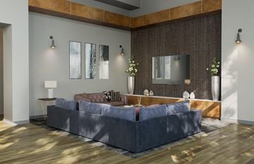 Colorado Springs apartment for rent - A modern living room with a grey sofa and a wooden floor.