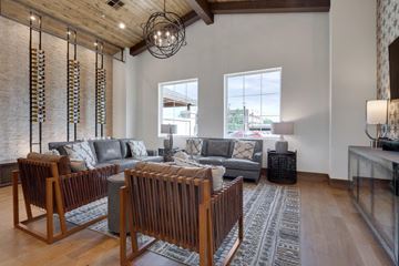 Santa Fe apartment for rent - A living room with a grey couch and a wooden coffee table.