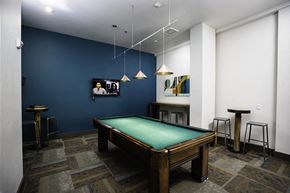 Seattle apartment for rent - A pool table in a room with a blue wall.