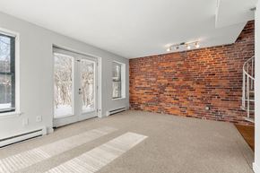 Cambridge apartment for rent - A room with a brick wall and a carpeted floor.