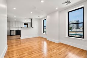Cambridge apartment for rent - 440-7 an empty living room with a large window and a kitchen