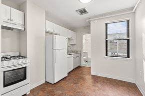 Cambridge apartment for rent - A kitchen with white appliances and a window.