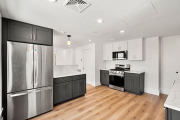 Cambridge apartment for rent - a renovated kitchen with stainless steel appliances and white cabinets