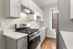 Cambridge apartment for rent - a kitchen with stainless steel appliances and white cabinets