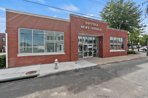 Suffolk apartment for rent - the front of a brick building with the words suffolk news herald