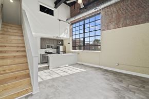 Suffolk apartment for rent - an open living room with a kitchen and a large window