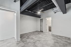 Suffolk apartment for rent - the living room of a home with white walls and a gray floor and a door