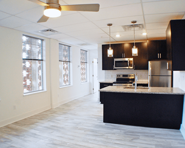 Richmond apartment for rent - A kitchen with a black counter top and stainless steel appliances.