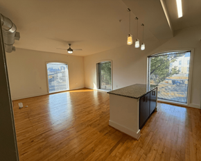 Richmond apartment for rent - A room with wooden floors and a kitchen island.