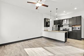 Richmond apartment for rent - A modern kitchen with a white island and black cabinets.