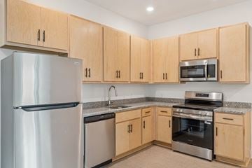 Newport News apartment for rent - A kitchen with wooden cabinets and stainless steel appliances.