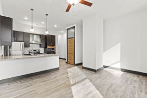 Richmond apartment for rent - A modern kitchen with a wooden floor and white walls.