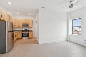 Newport News apartment for rent - A kitchen with a refrigerator, oven, and microwave.