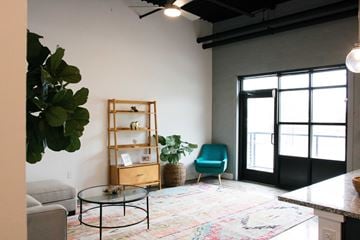 Norfolk apartment for rent - A living room with a glass table and a blue chair.