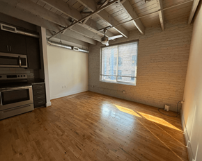 Richmond apartment for rent - A room with wooden floors and a window letting in sunlight.