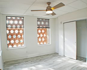 Richmond apartment for rent - A room with a ceiling fan and two windows.