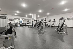 Richmond apartment for rent - A black and white image of a gym with various exercise equipment.
