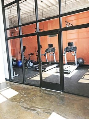 Norfolk apartment for rent - A gym with orange walls and a glass wall.