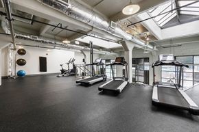 Richmond apartment for rent - A gym with treadmills, exercise balls, and weights.
