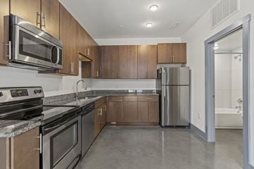 Richmond apartment for rent - A kitchen with brown cabinets and stainless steel appliances.
