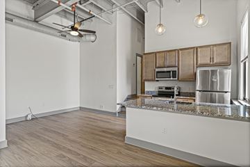 Richmond apartment for rent - A kitchen with wooden cabinets and a granite countertop.