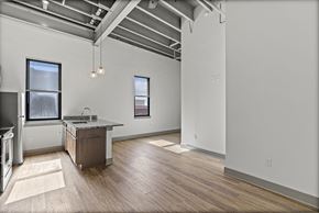 Richmond apartment for rent - A kitchen with a wooden floor and a window.