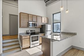Richmond apartment for rent - A kitchen with a granite countertop and stainless steel appliances.